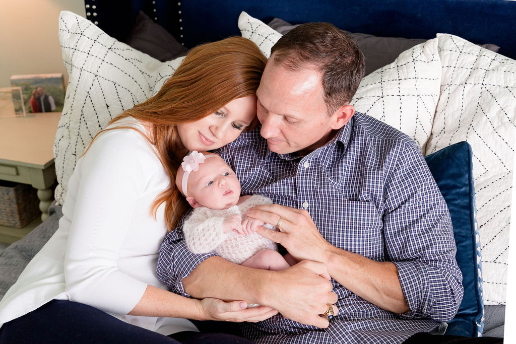 Kevin and his wife holding their newborn daughter