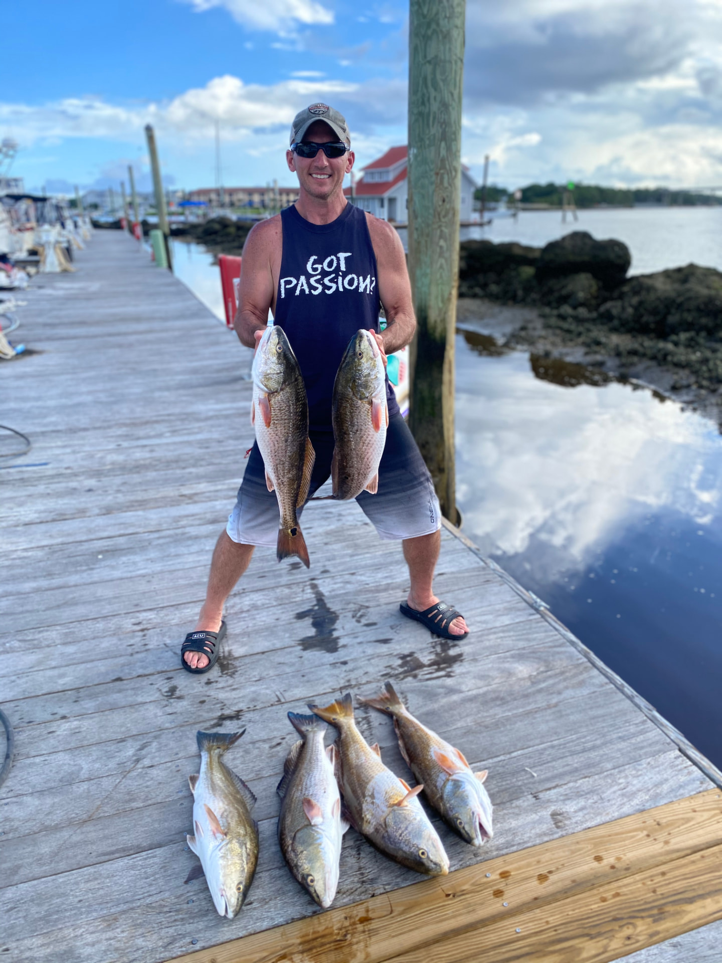 Kevin holding a day's catch of redfish on the dock