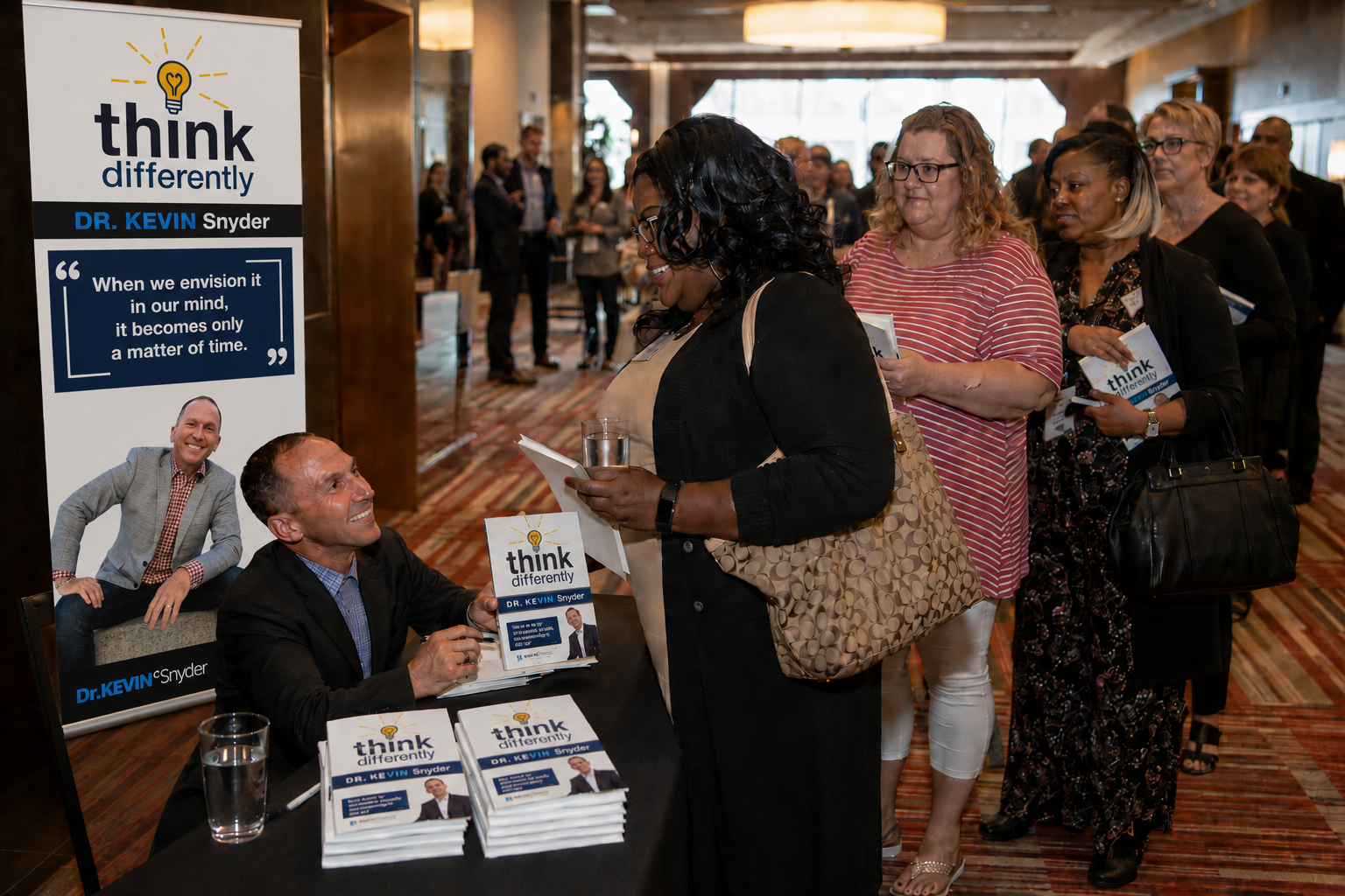 Kevin signing copies of think differently