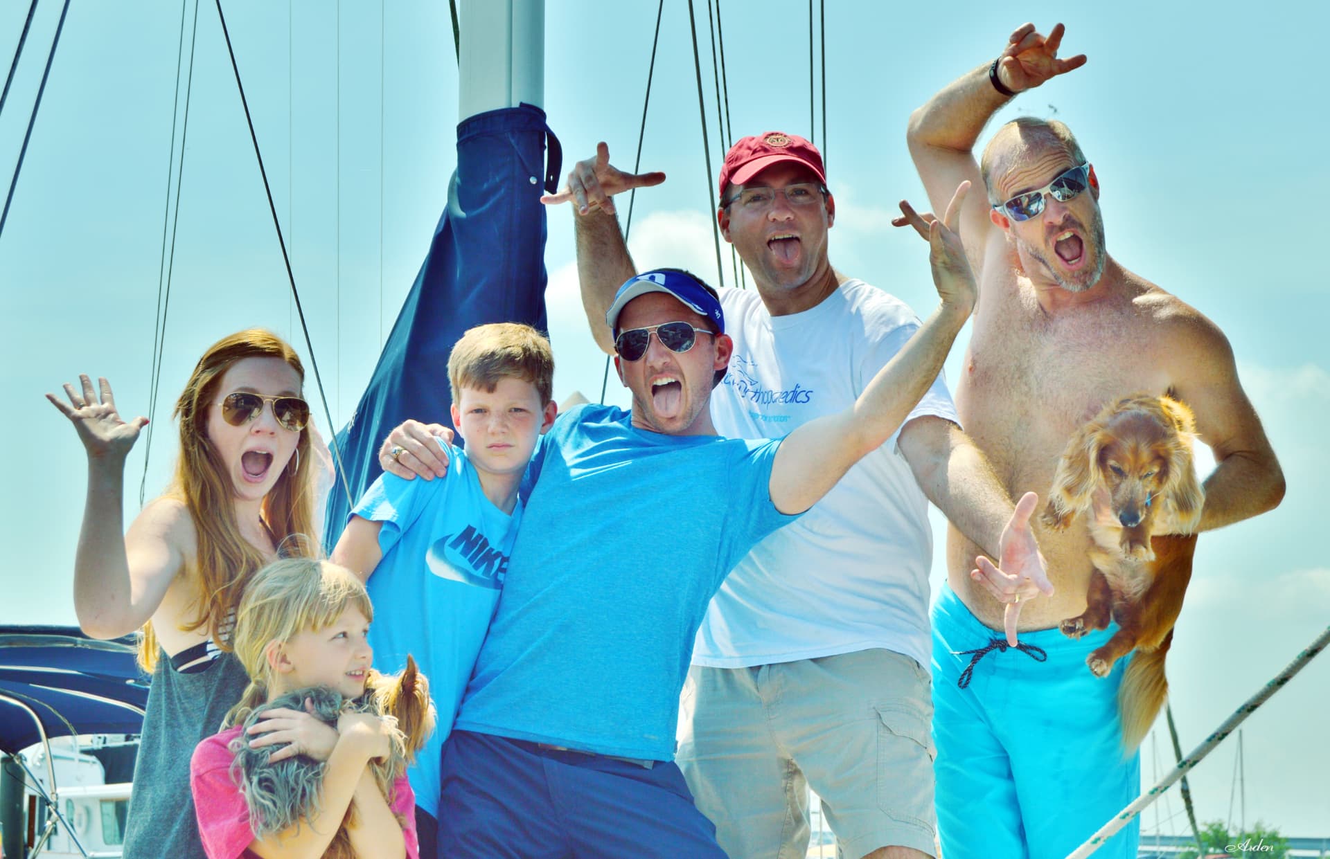 Kevin and family being playful on a sailboat