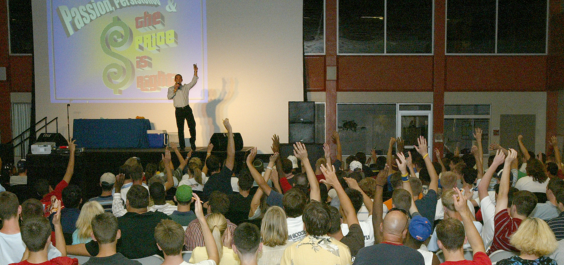Students with hands raised during a Kevin Snyder keynote