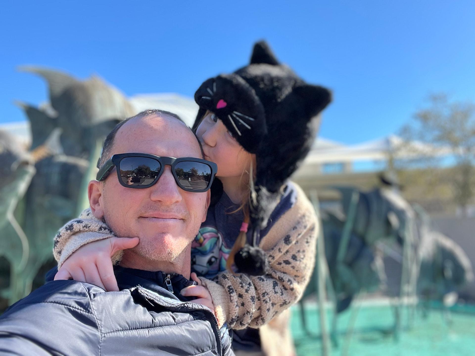 Kevin's daughter kissing his cheek on a day out