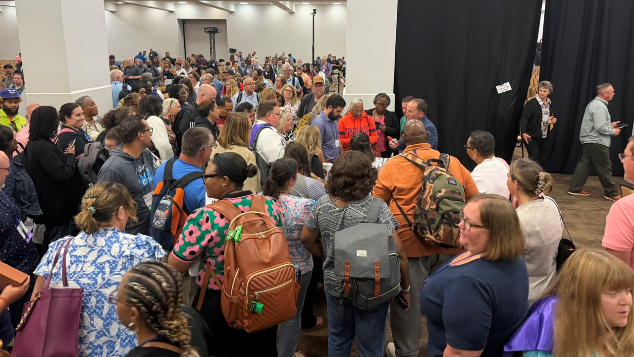 Attendees lined up at Kevin's book signing table after a keynote