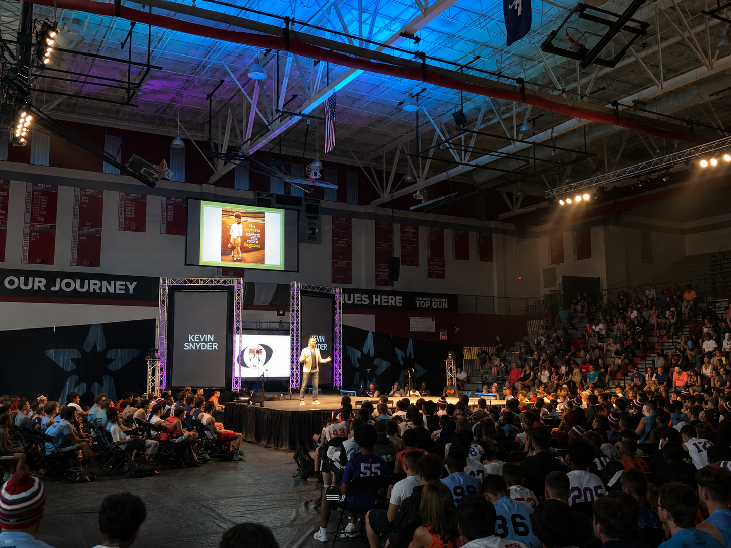 Kevin Snyder speaking to student-athletes in an arena